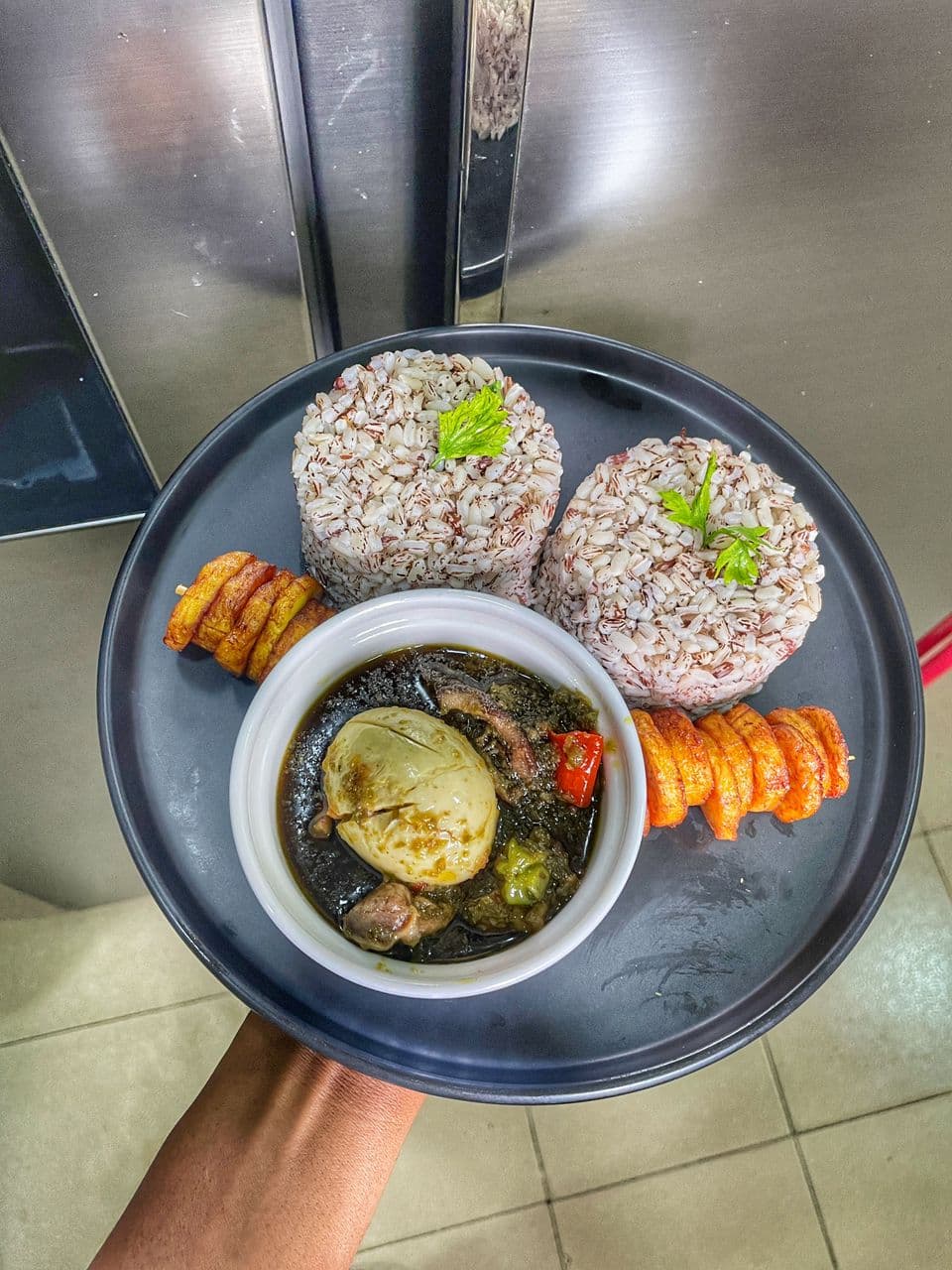 Waakye and accompaniments prepared by a Kimolar chef in Accra