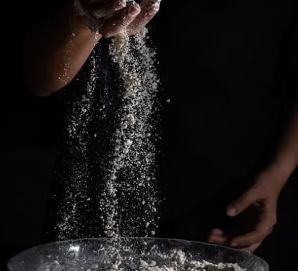 Pastry chef dusting sugar